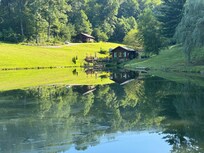 View of the cabin from the other side of the pond.
