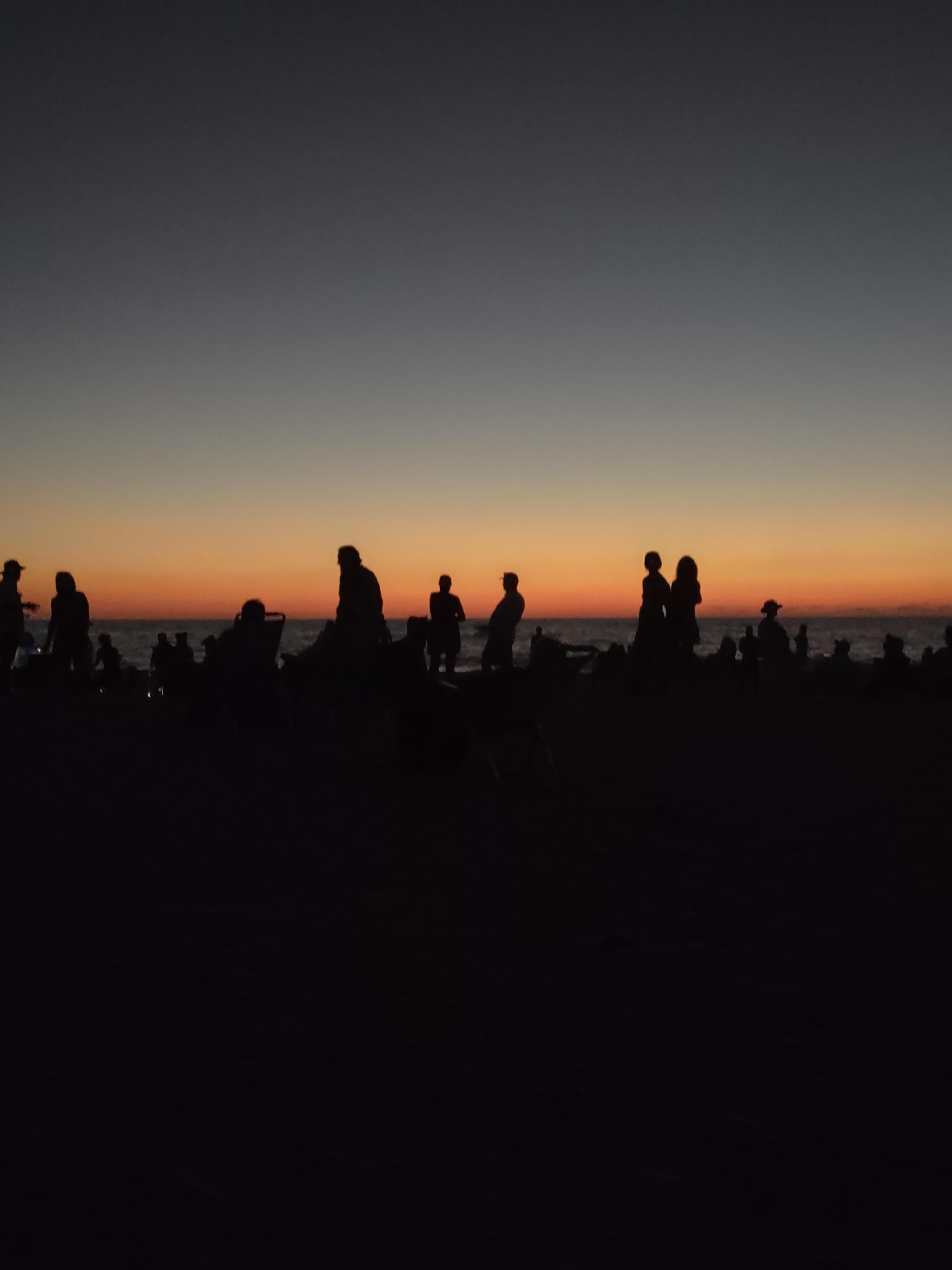 Silhouettes against the sunset, while listening  to the Drums on Nokomis Beach, an easy 5 minute walk south, on the beach, from Escape Resort & Marina.