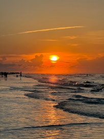Sunrise over the ocean standing on the beach in front of the villa.