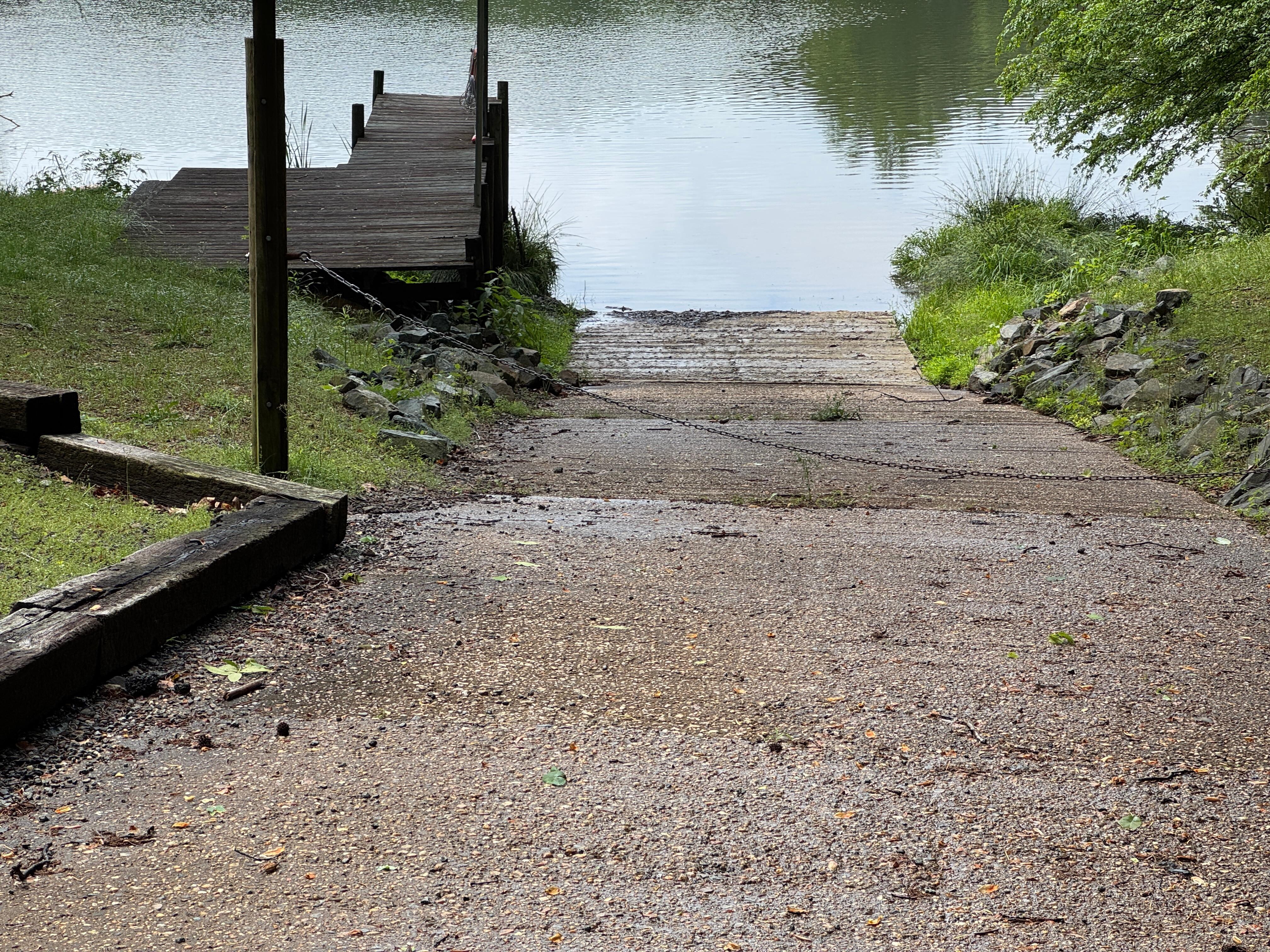 Nice ramp to get canoe or kayak to the lake but blocked by chain. Owners couldn't get a key from the HOA. HOA toke home owner there was not a chain across the ramp. See chain in picture