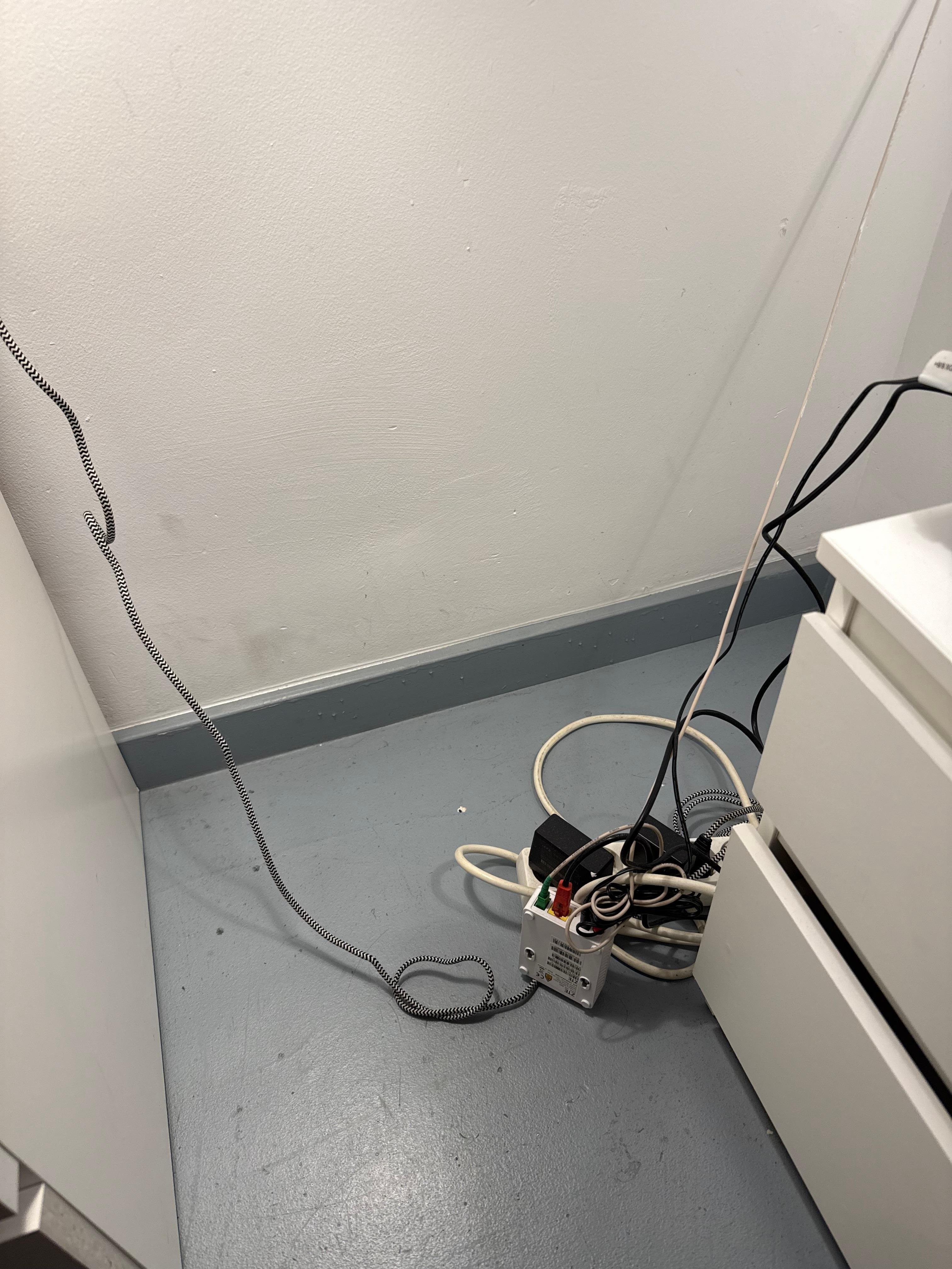 Exposed wired next to bed.