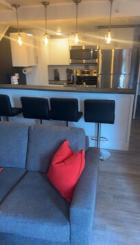 Upstairs kitchen / living room with all amenities including full size fridge, stove, dishwasher & microwave (includes utensils, cookware, plates, cups & cleaning products)