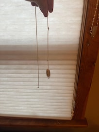 The unattached cord to the blinds