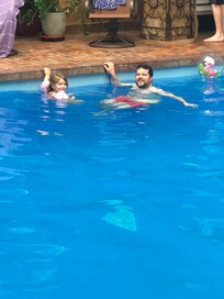 Granddaughter and her Uncle enjoying the pool.