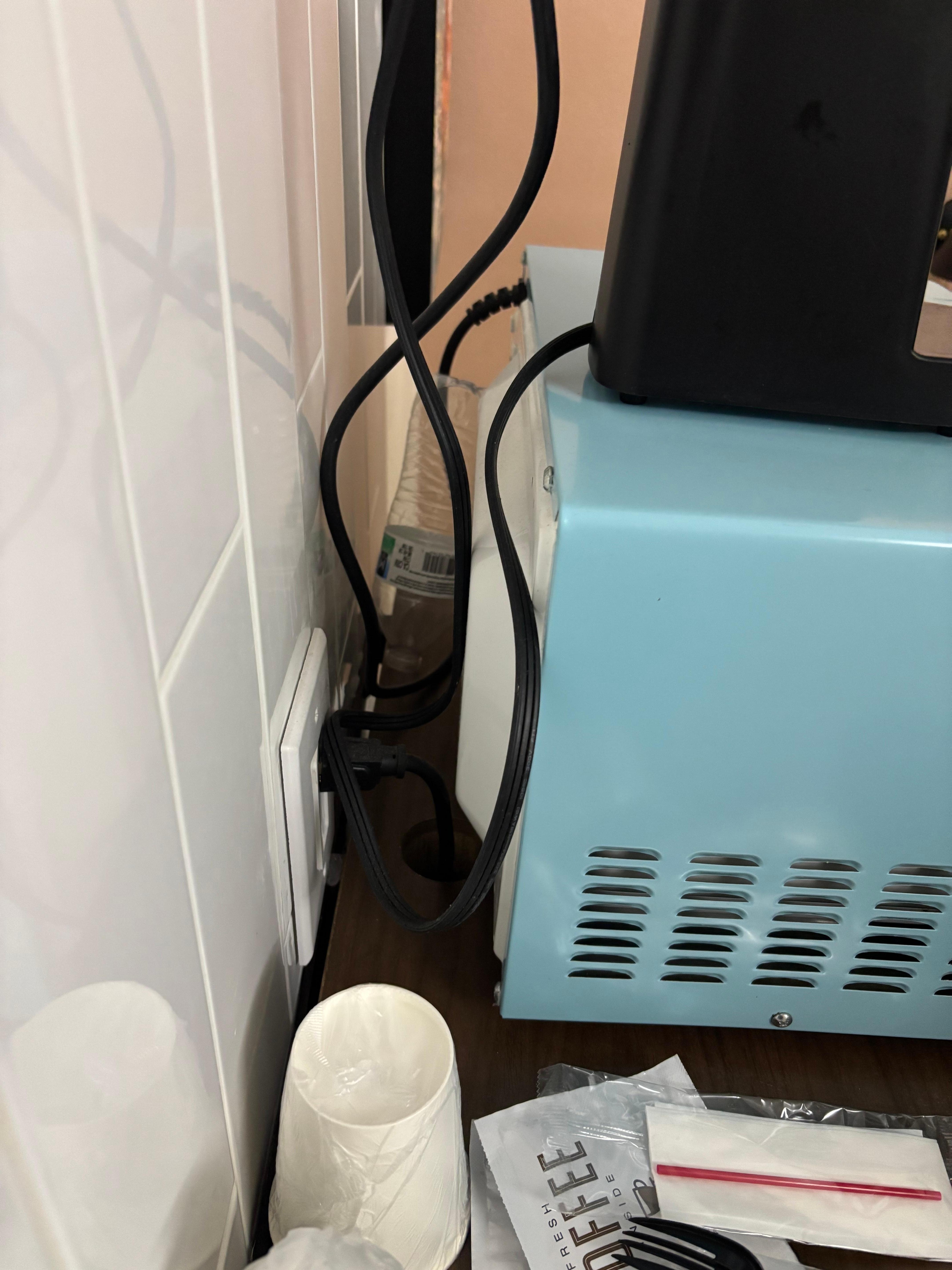 Outlet kept sparking, and bottles left behind the microwave