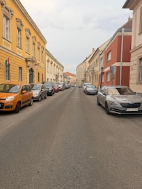 Hotel street scene to left in front of hotel and one way car path
