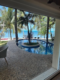 View from the living room looking out into the backyard and private beach area.