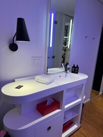 Sink and vanity in hall just after entering room.