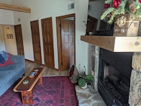 The bedroom doors off the living area and fireplace