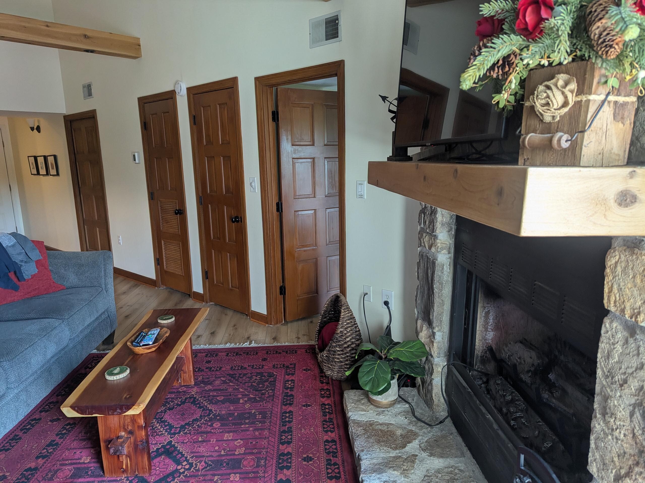 The bedroom doors off the living area and fireplace