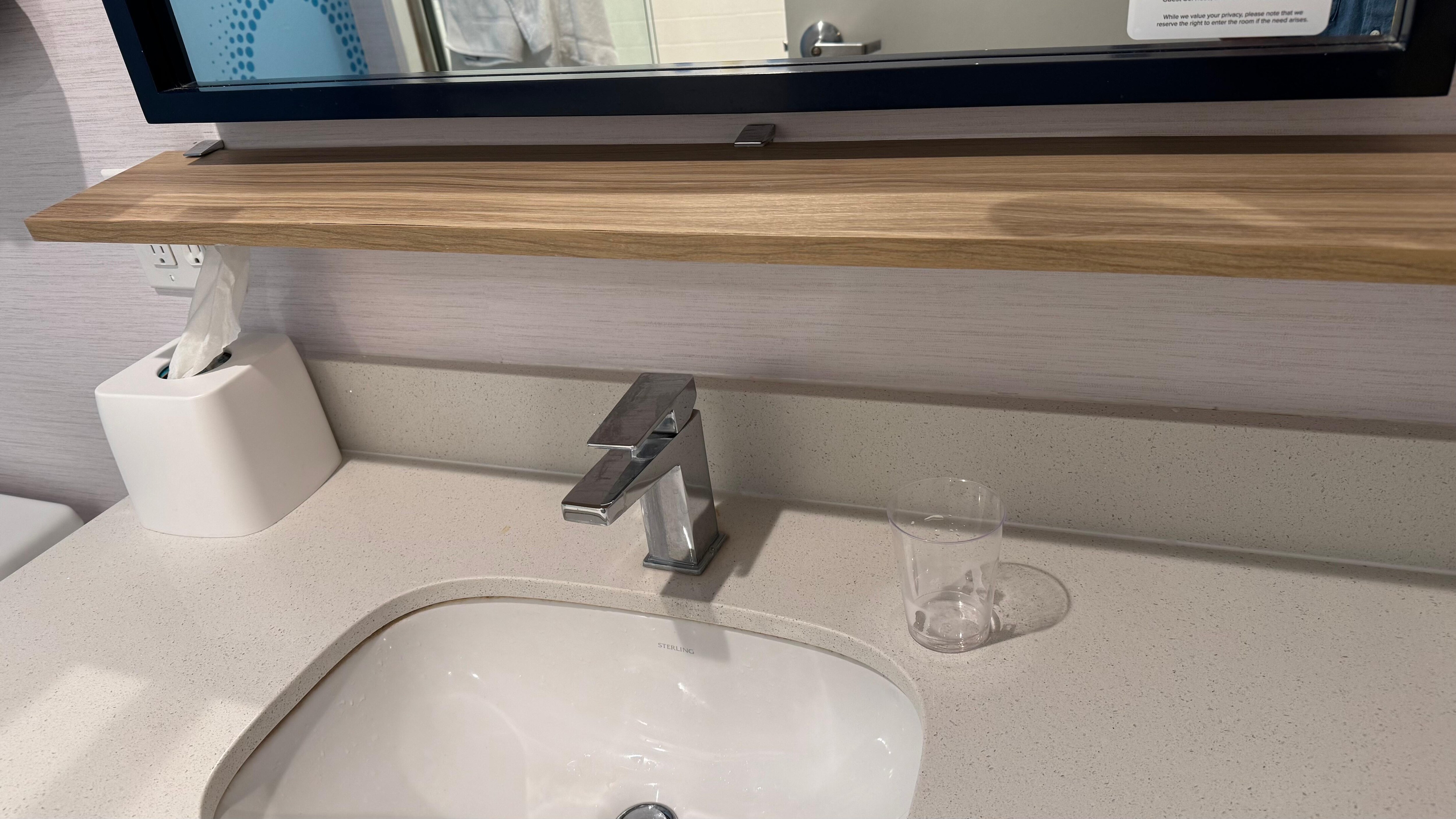 The shelf in bathroom was broken or tilted.