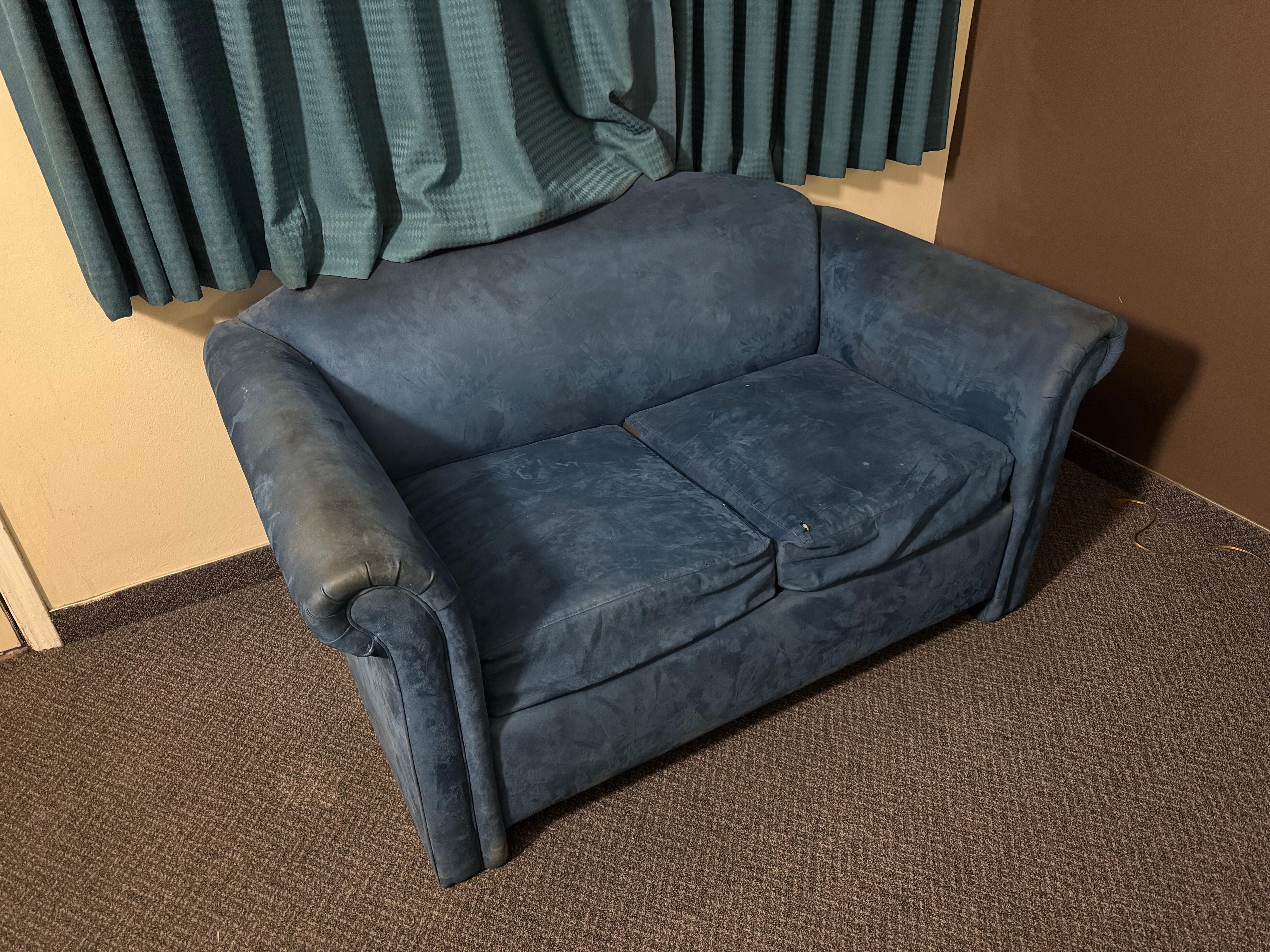 Stained and cigarette burned couch