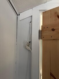 Bedroom extension chords hanging from inside wall