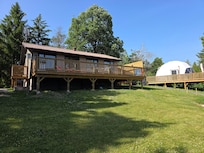 Sun deck with loungers, a table & chairs, umbrella & giant Connect 4 game.