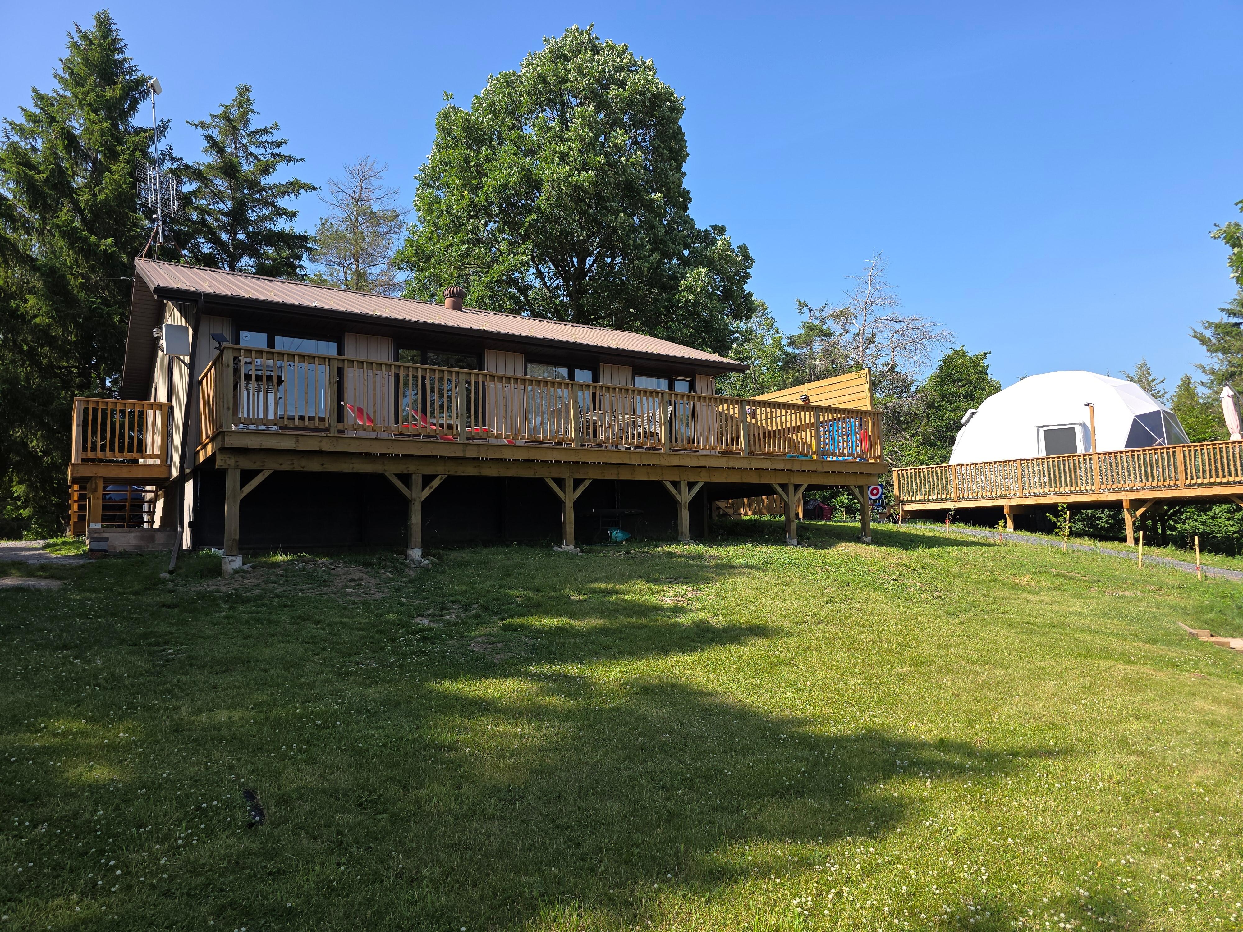 Sun deck with loungers, a table & chairs, umbrella & giant Connect 4 game.