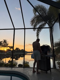 Grilling dinner at sunset
