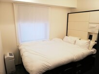 Picture of the room, taken from the hallway. Do note that this was after I quickly fixed the bed myself just for this photo. The staff does a much better job!
