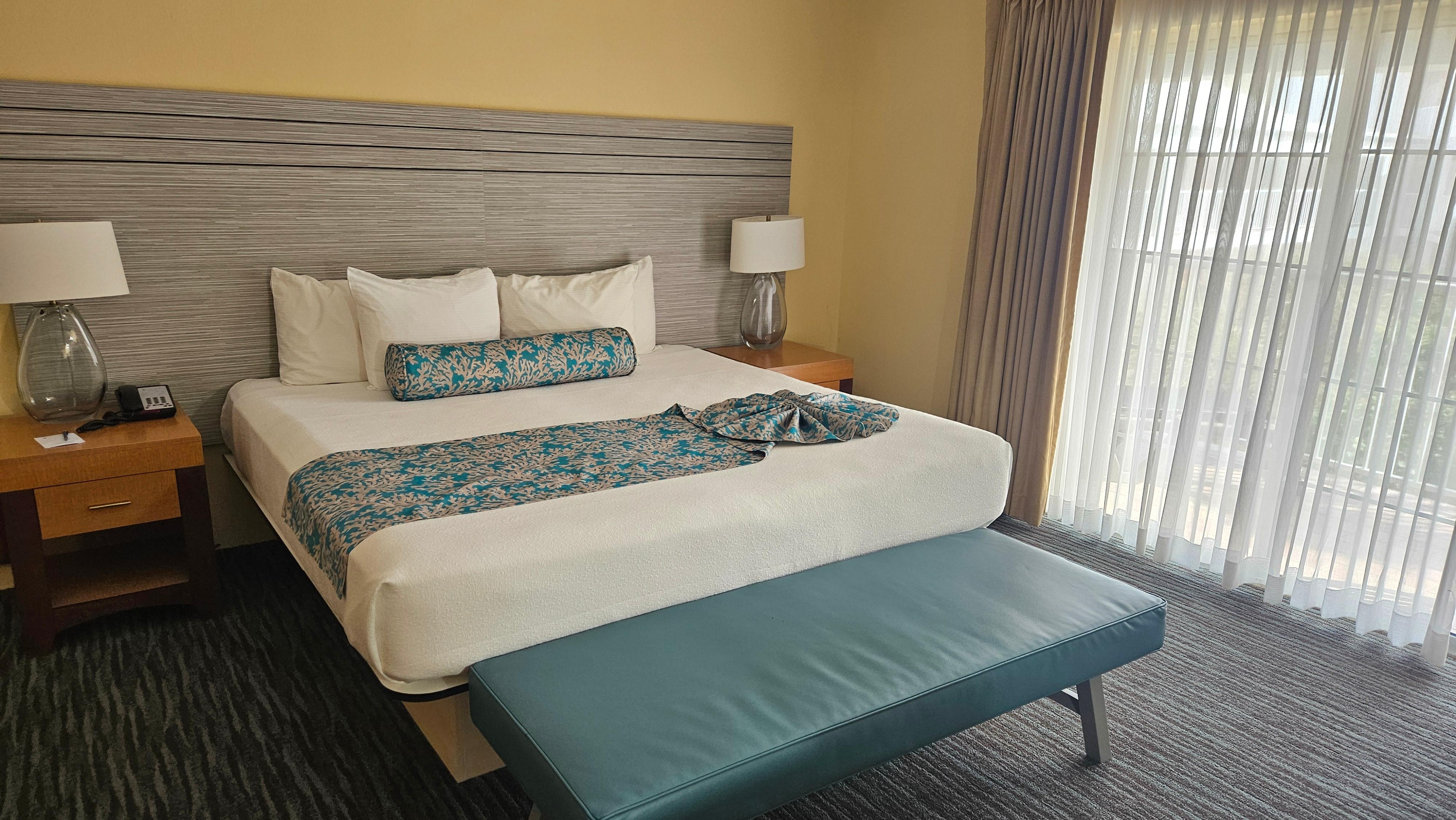 A nice clean & comfortable room with table & chairs & a private deck