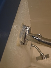 The shower curtain rod is glued to the wall