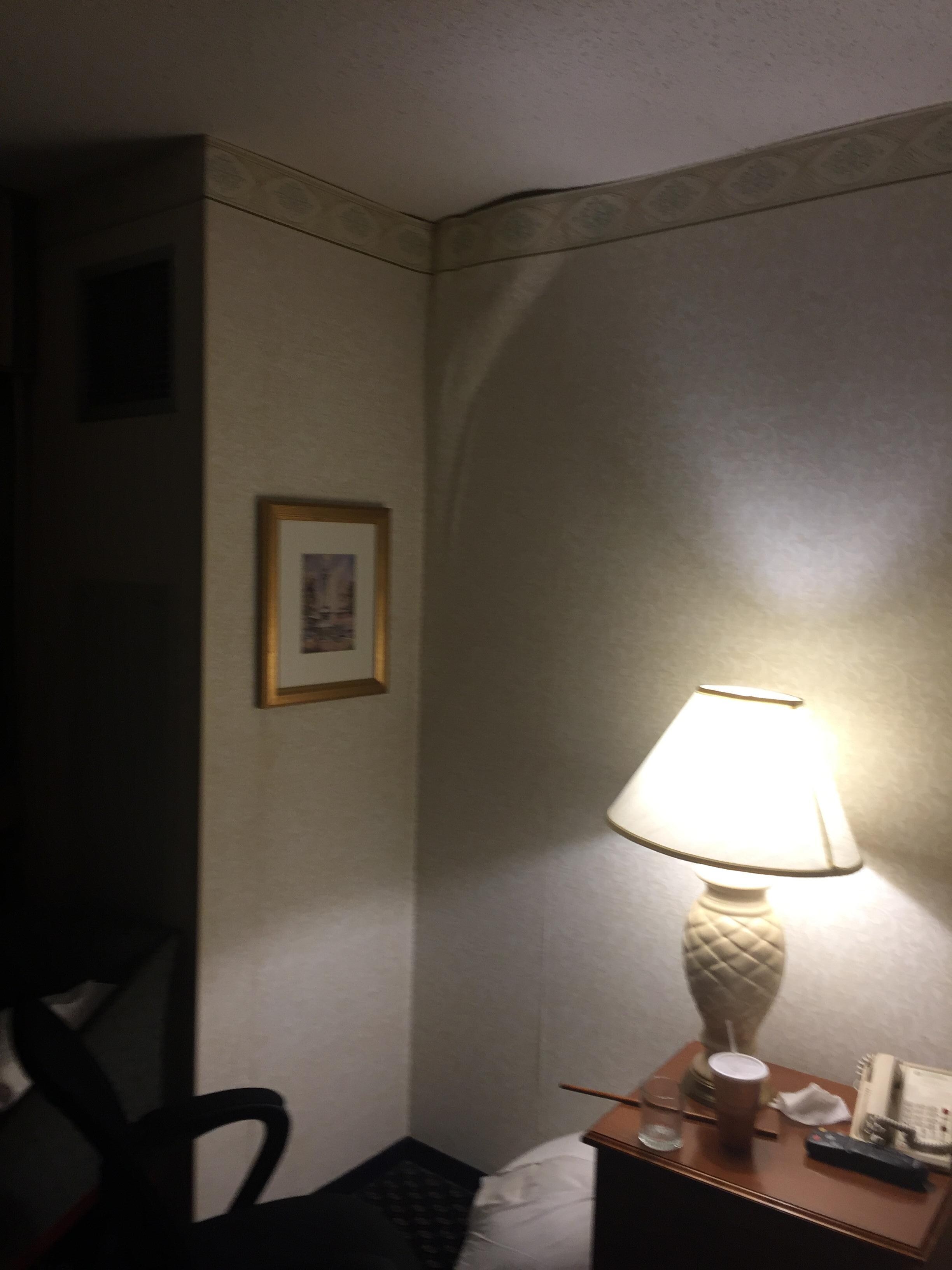 Wallpaper falling loose from wall.