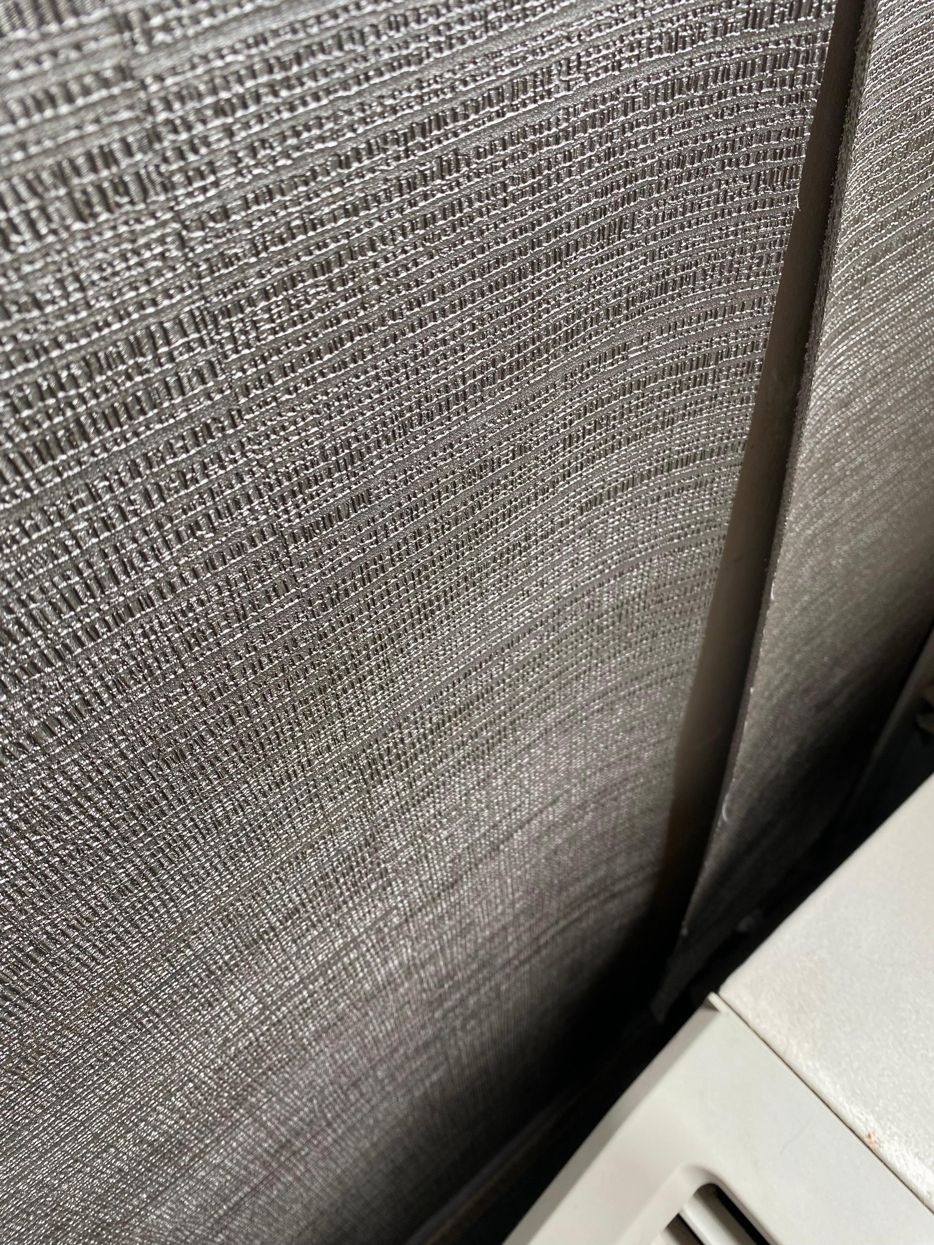 Wall paper peeling from wall.