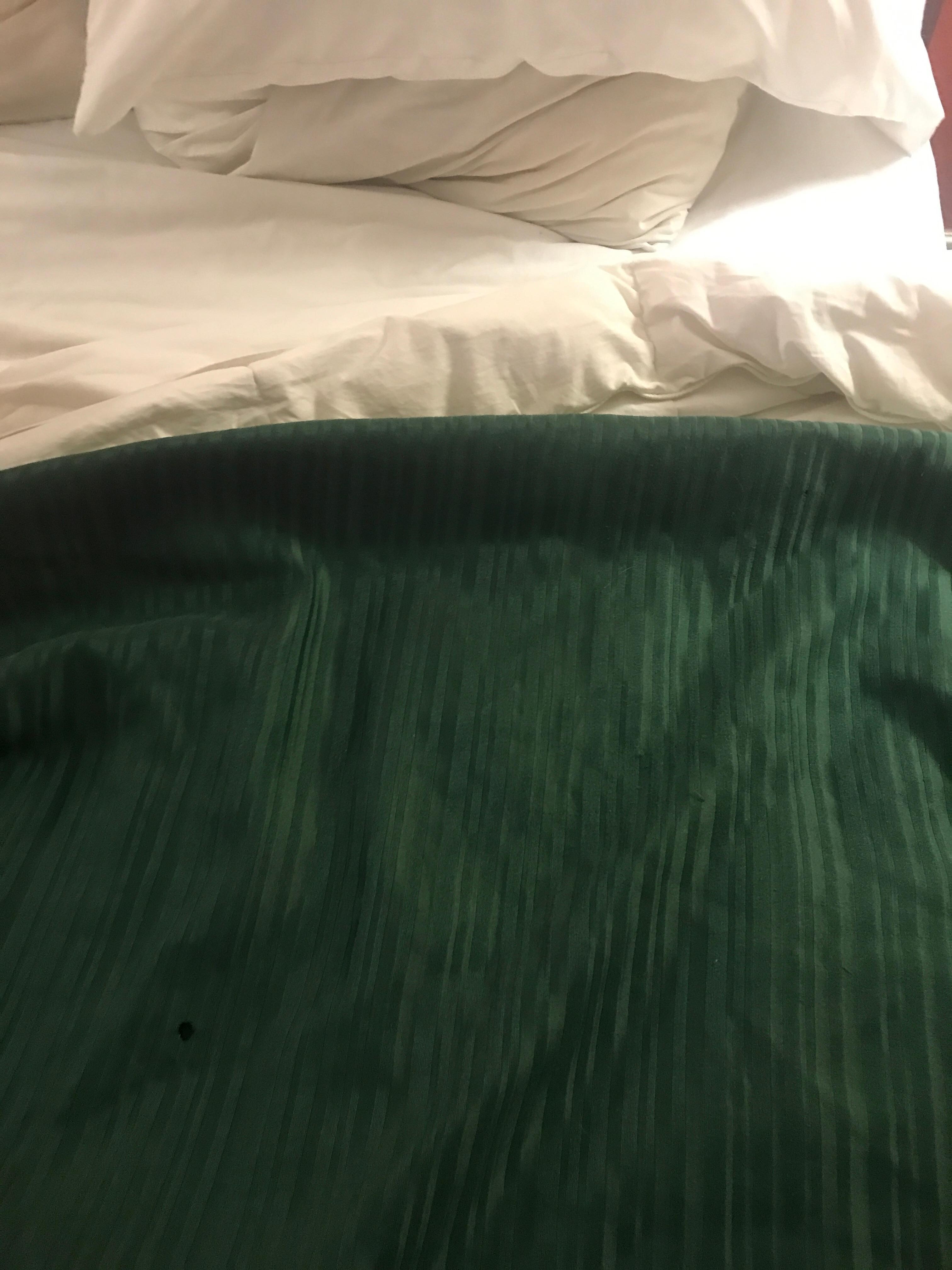 One of several burns in the bedspread