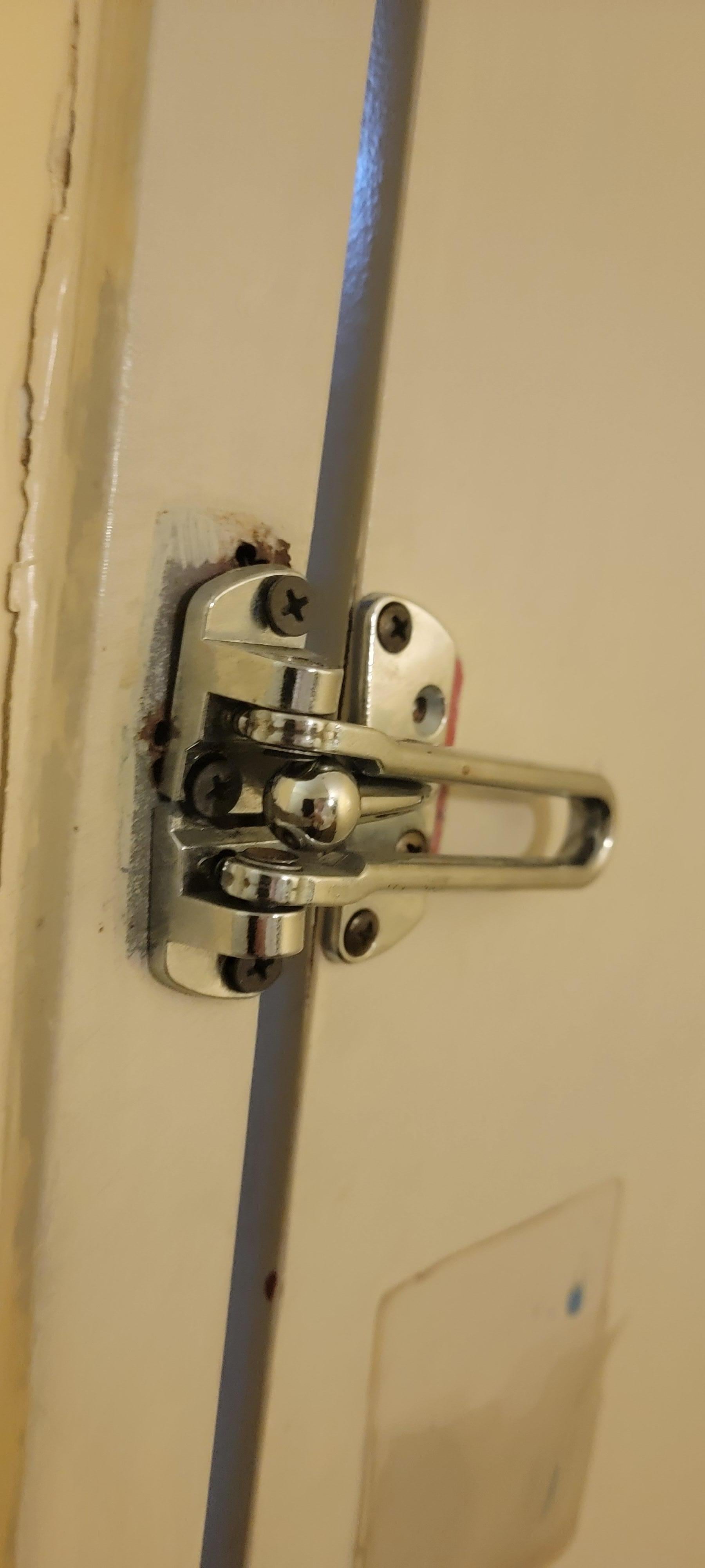 Security hasp was barely attached to frame, could see light thru door to hallway