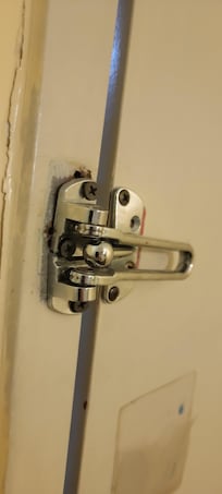 Security hasp was barely attached to frame, could see light thru door to hallway