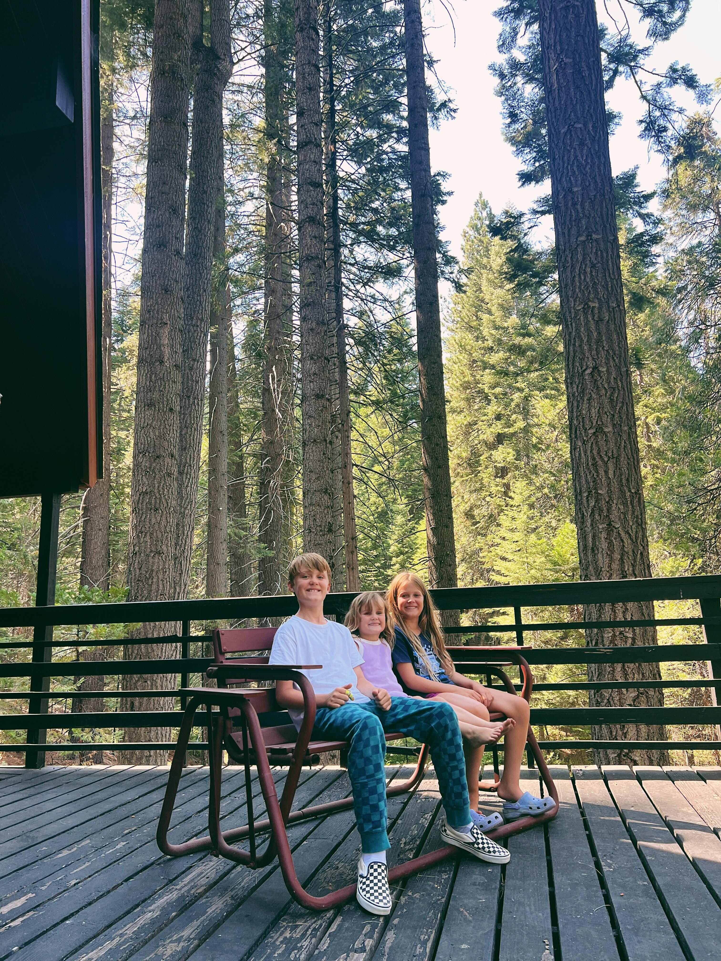 kids enjoying the glide rocker on the big beautiful deck