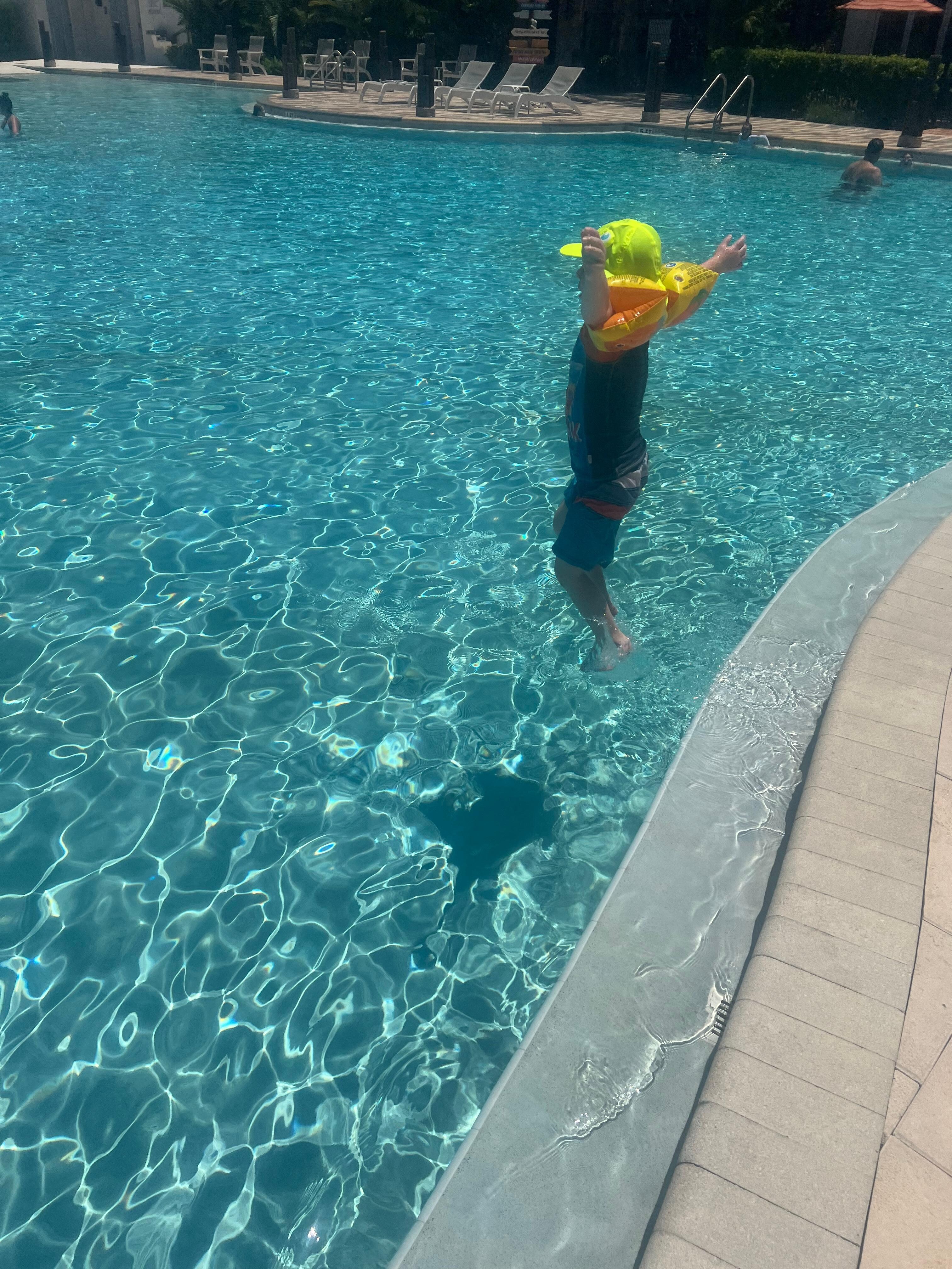 My son learning to jump in the pool by himself