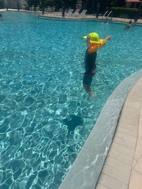 My son learning to jump in the pool by himself