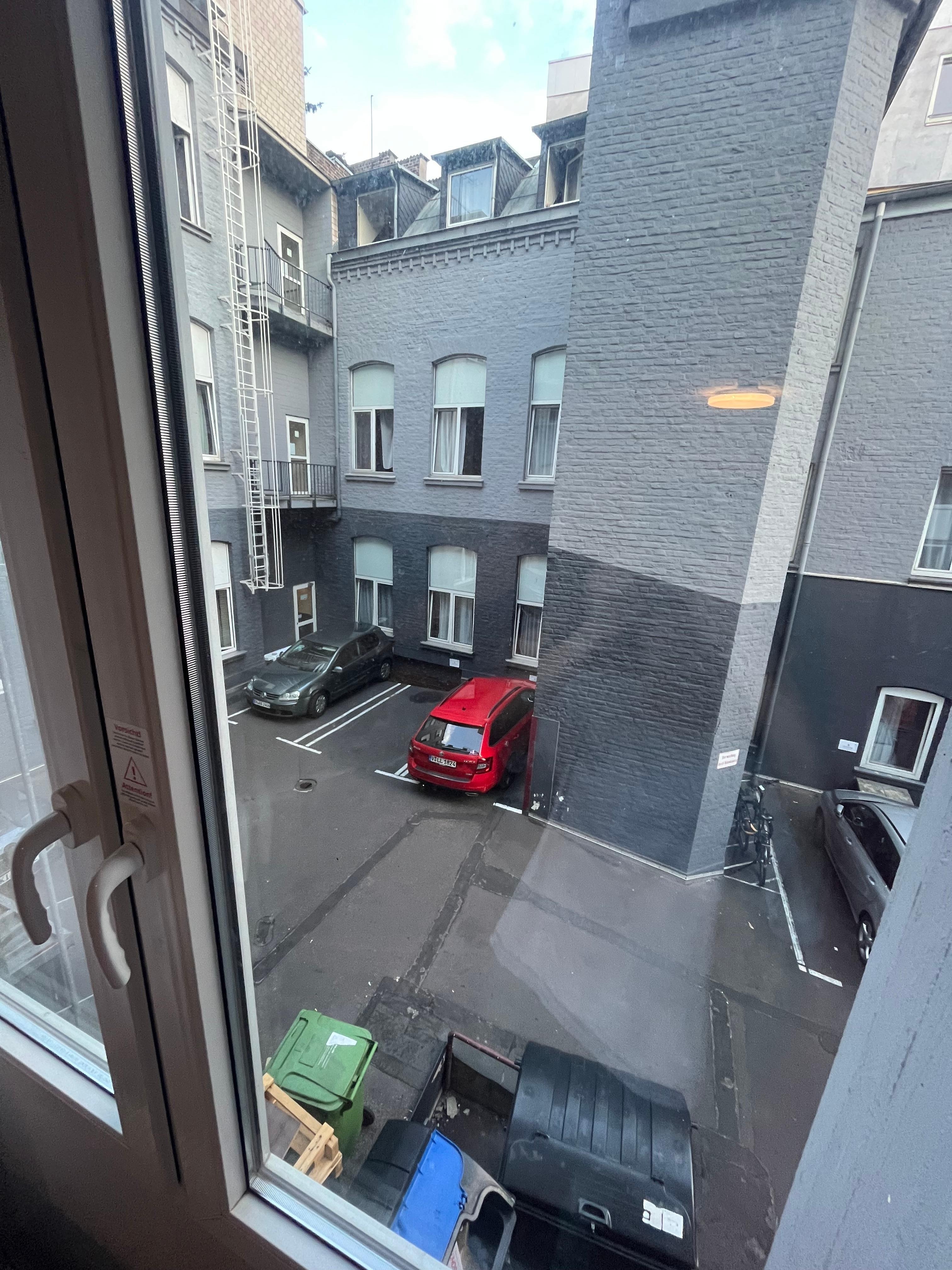 Our view from the window, the open dumpster right below our window did not smell nice in the summer heat.