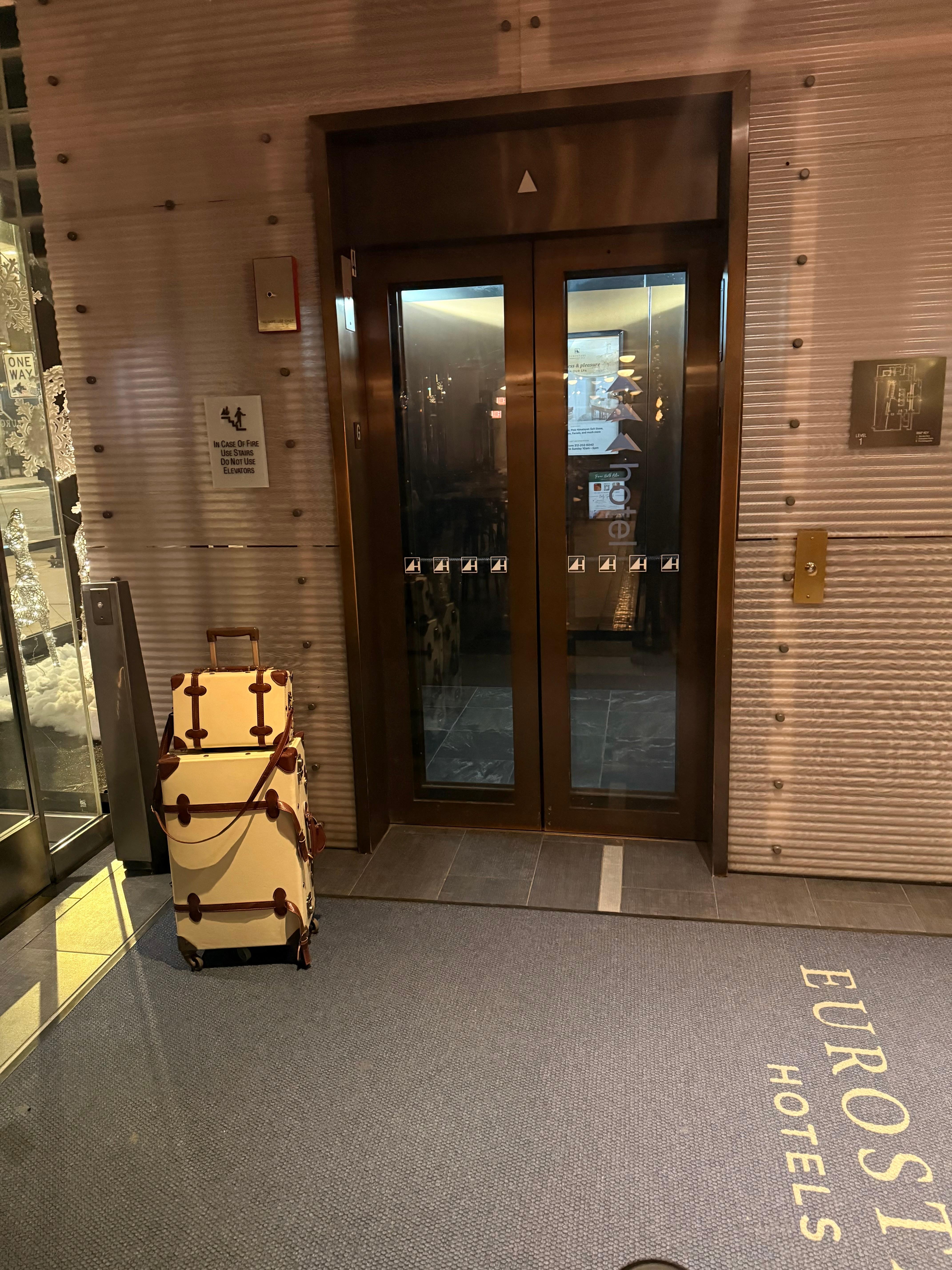 inside of the hotel, right by the elevator, my luggage was ready