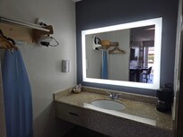 Note hand soap and lotion dispensers on wall left of sink. Lacked lighting in vanity area as well.