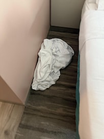 Bedding left on floor after room service