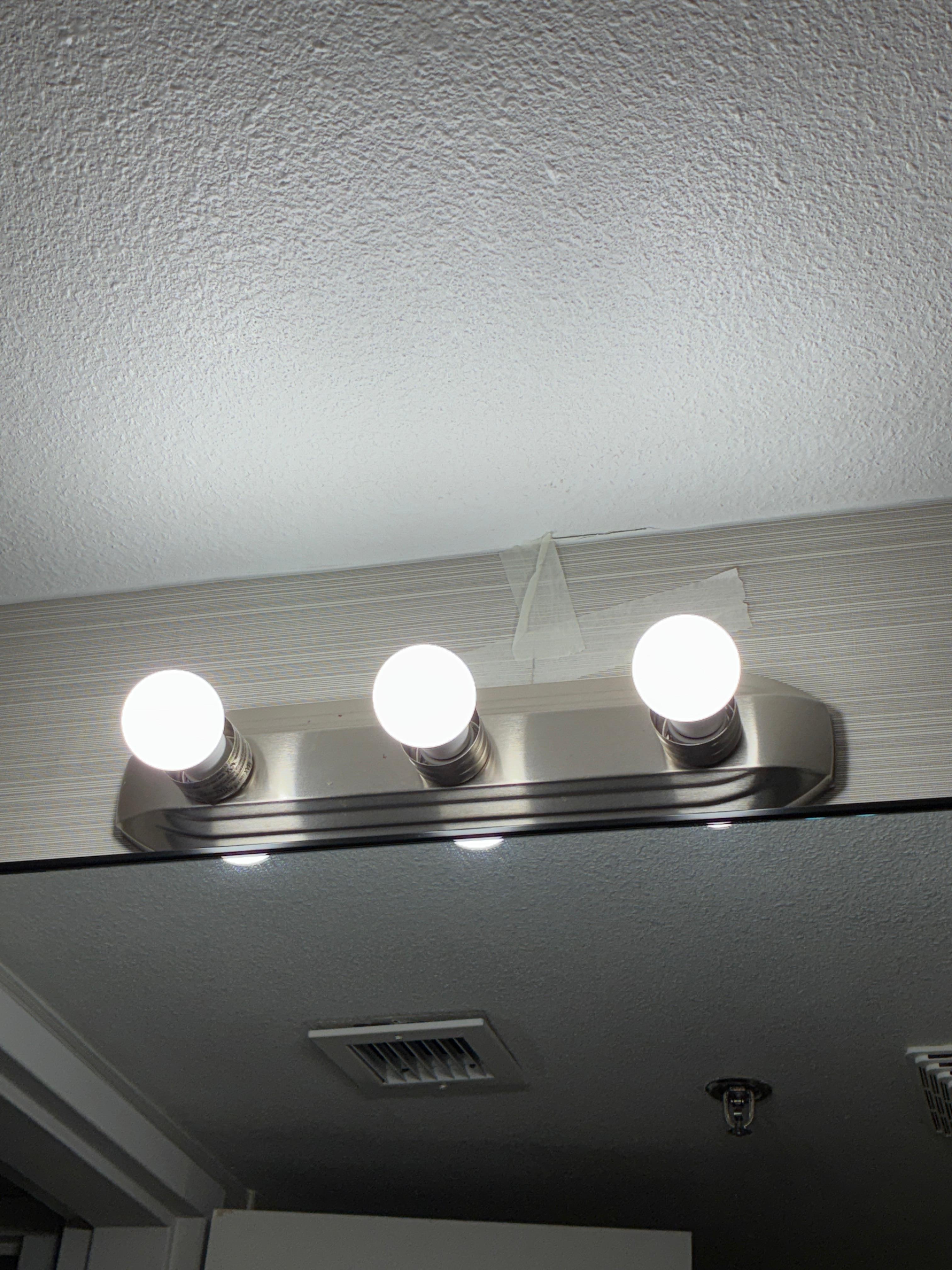 Tape above the bathroom vanity light