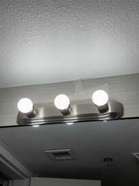 Tape above the bathroom vanity light