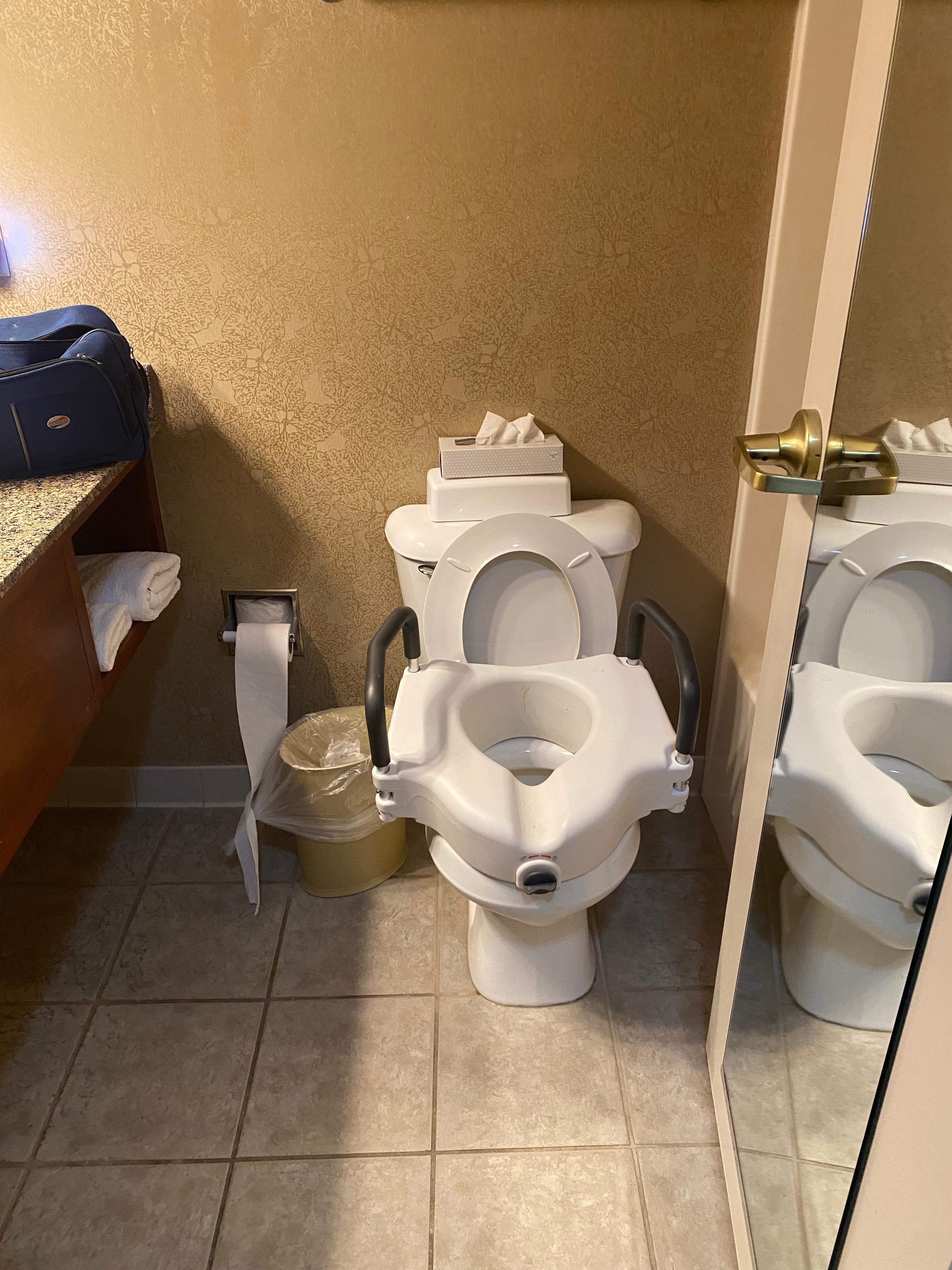 1/4 inch clearance from raised toilet to door 