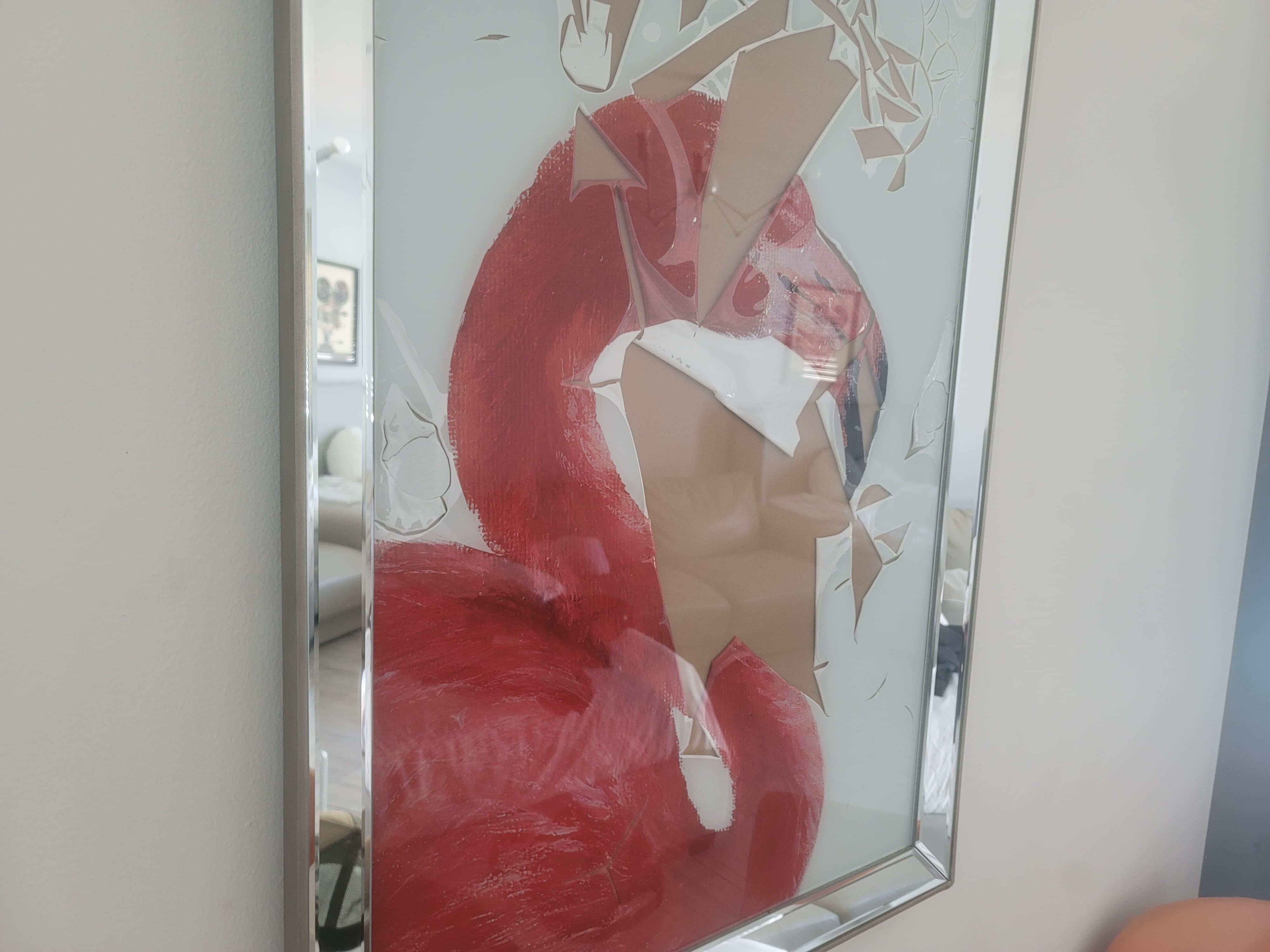 Damaged artwork in a frame.