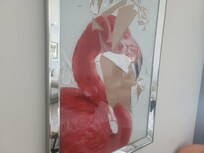 Damaged artwork in a frame.