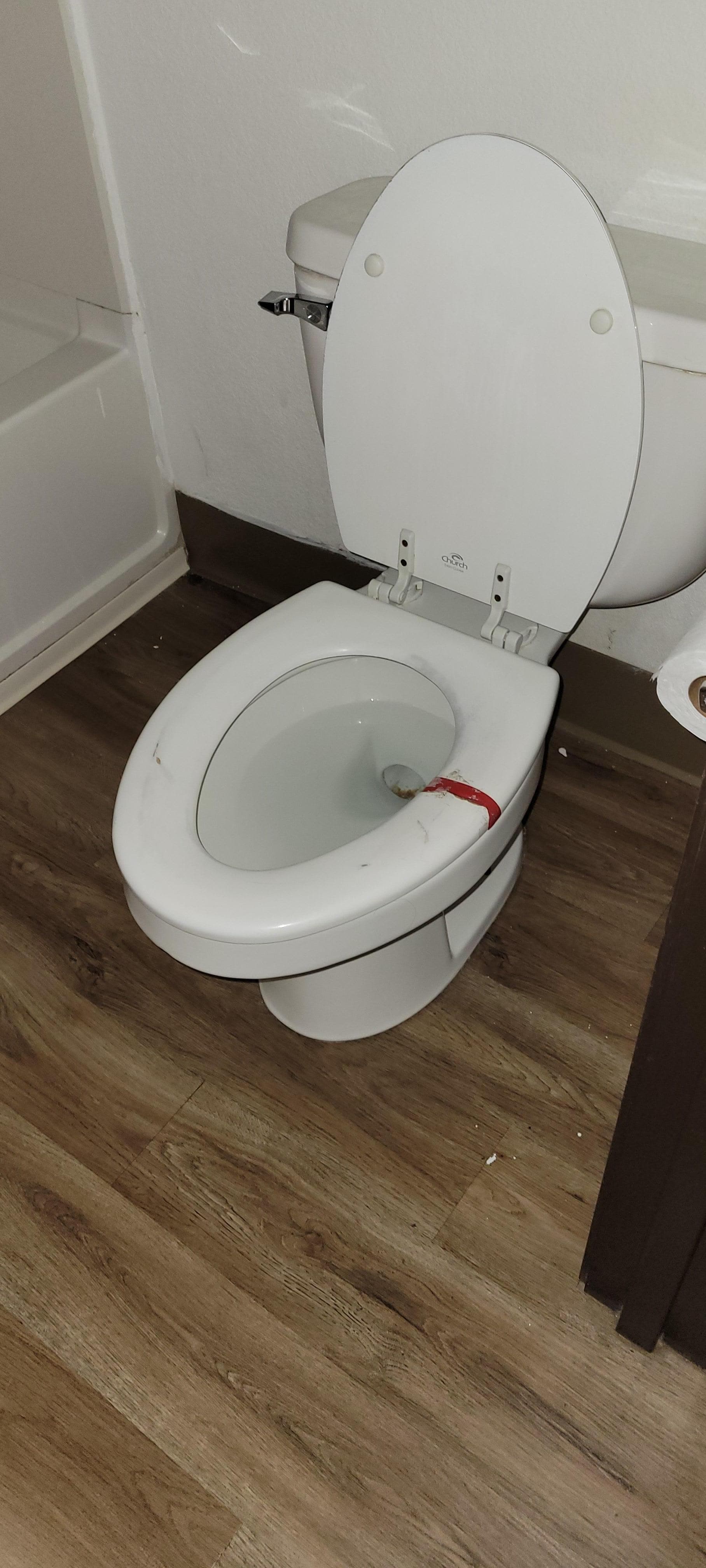 Cracked/broken toilet seat repaired with red duct tape