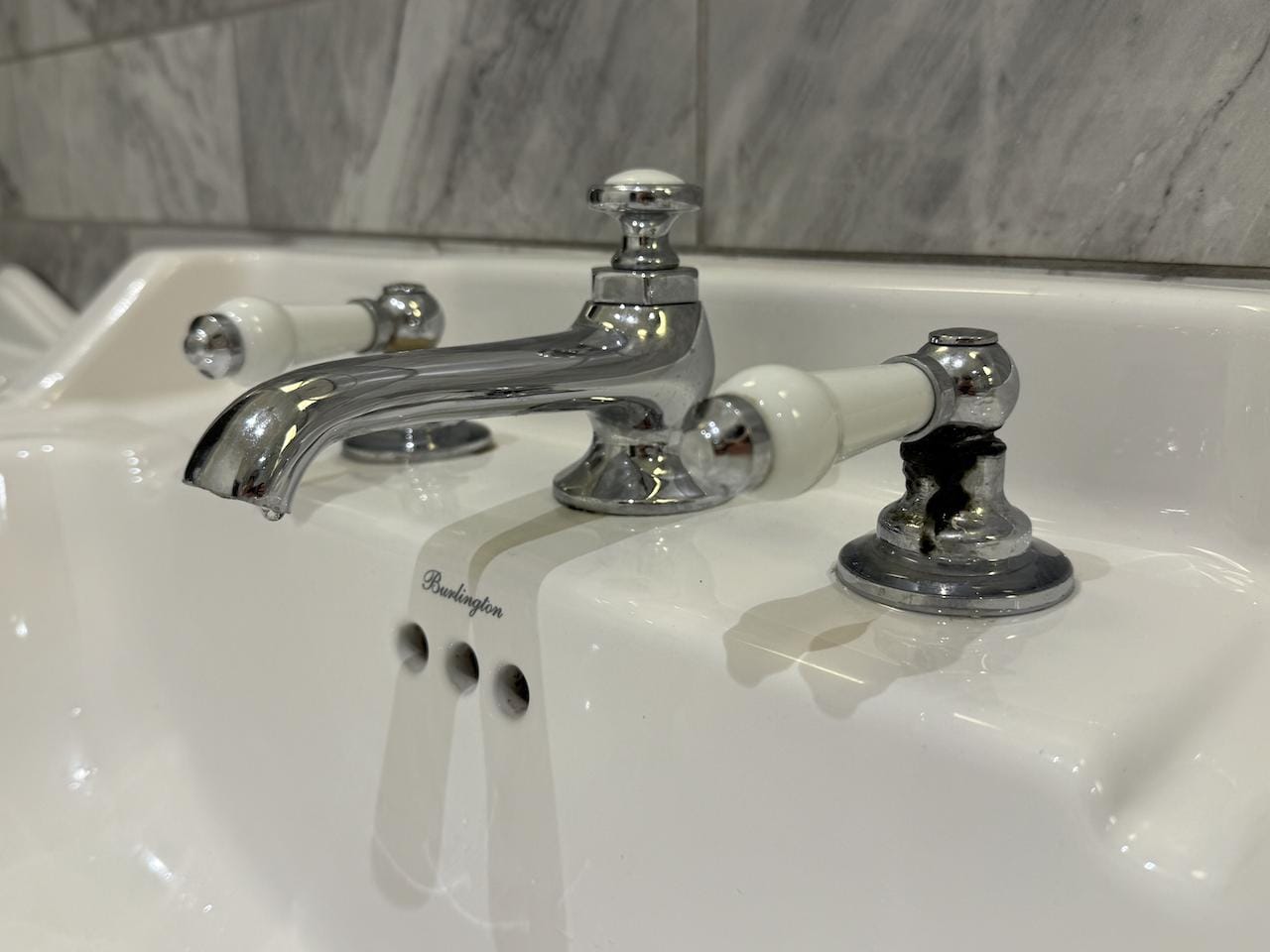Black grime/mould around tap