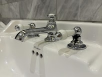 Black grime/mould around tap