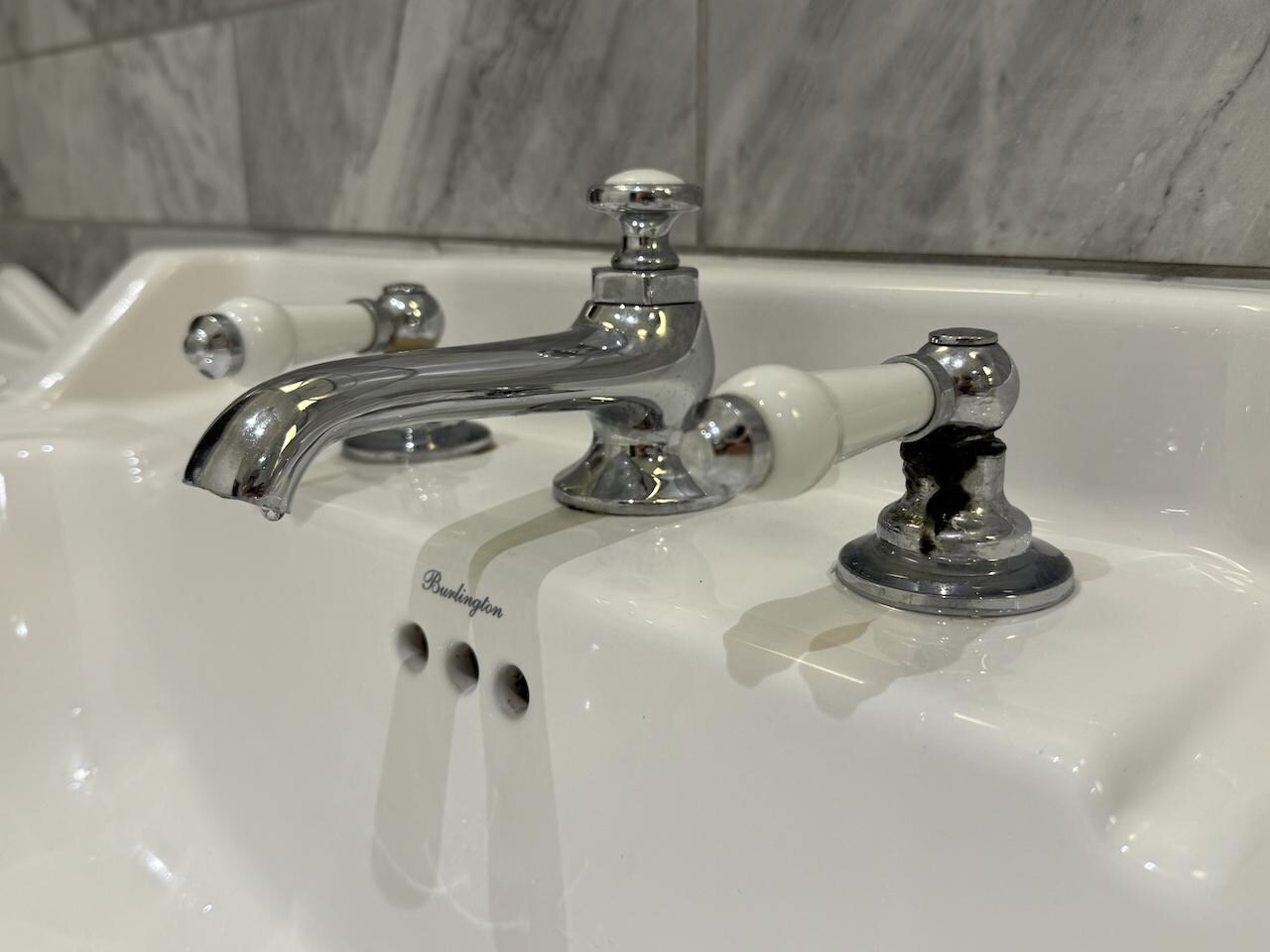 Black grime/mould around tap