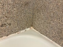 The caulking around bath tub.
