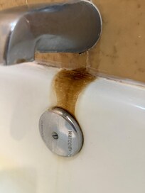 Leaking faucets with water stains.