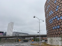 The brown building on the right is the parking garage. The tall white building on the left is the hotel.