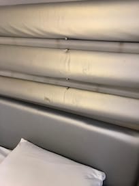 Scuffed grey headboard.