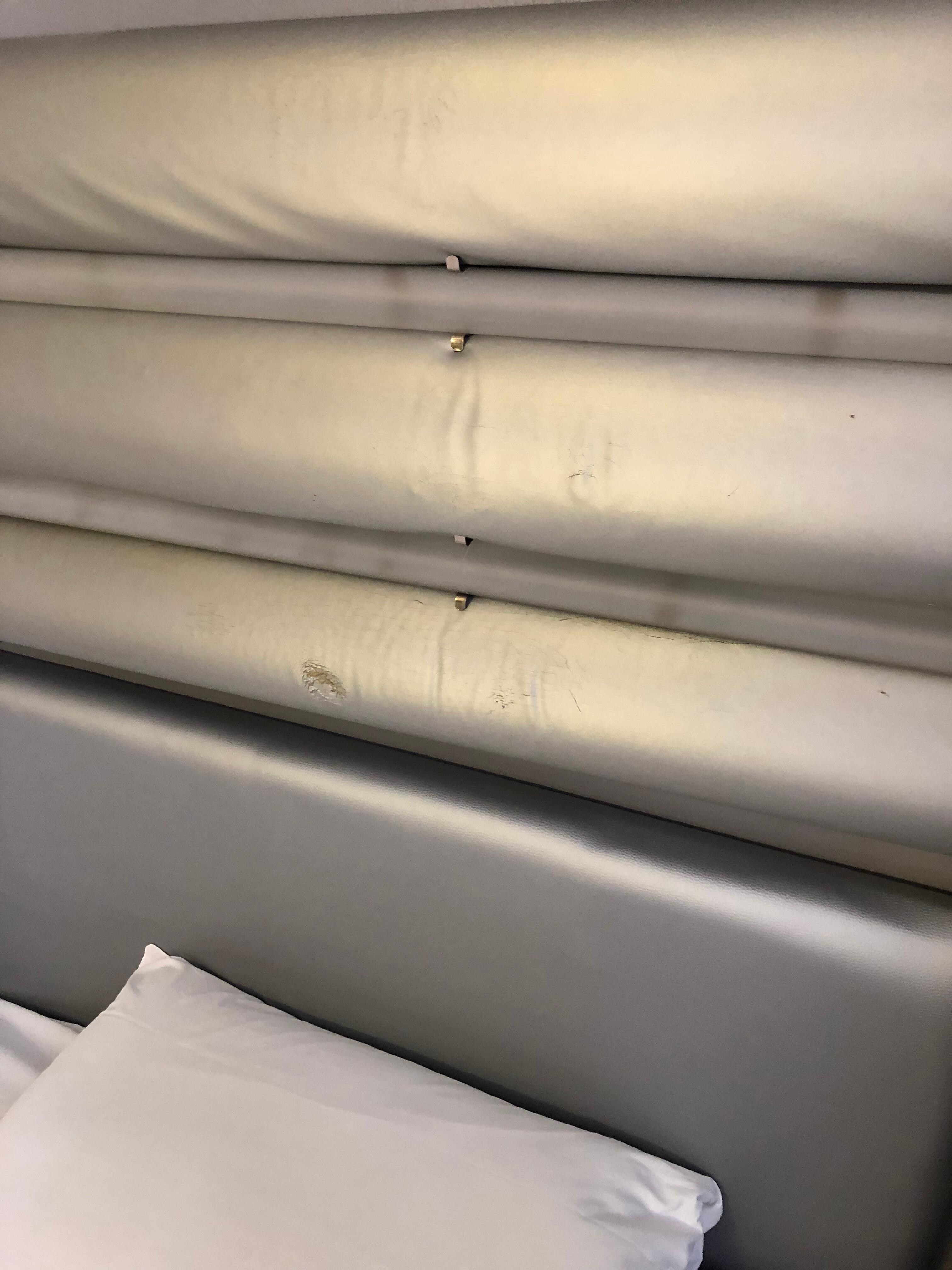Scuffed grey headboard.