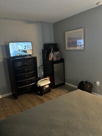 Entertainment and food area. Microwave on the smaller side. Mini fridge has an upper frozen space. Trash can behind (my) cooler.